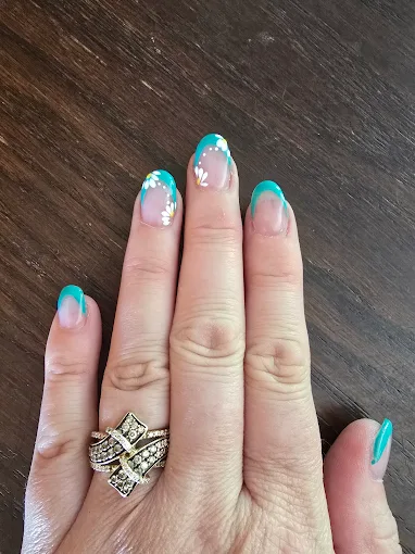 Teal French manicure with floral nail art at L.A. Nails